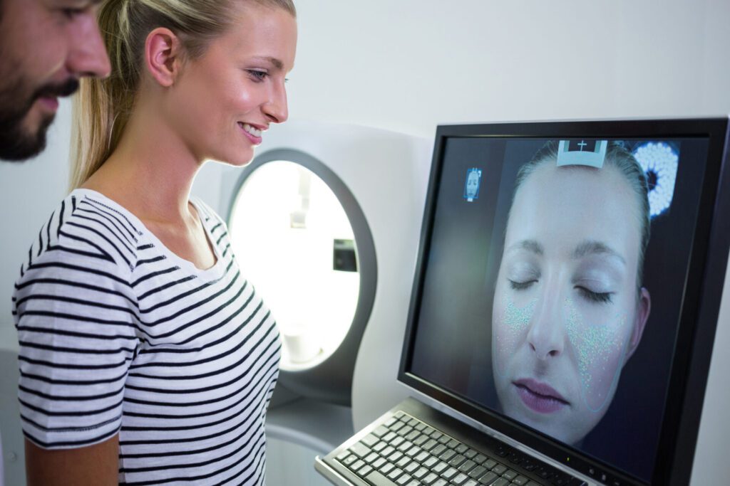 Woman looking mri scan report on computer screen in clinic
